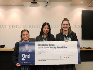 Three students from Adelaide Botanic High School posing with a prize